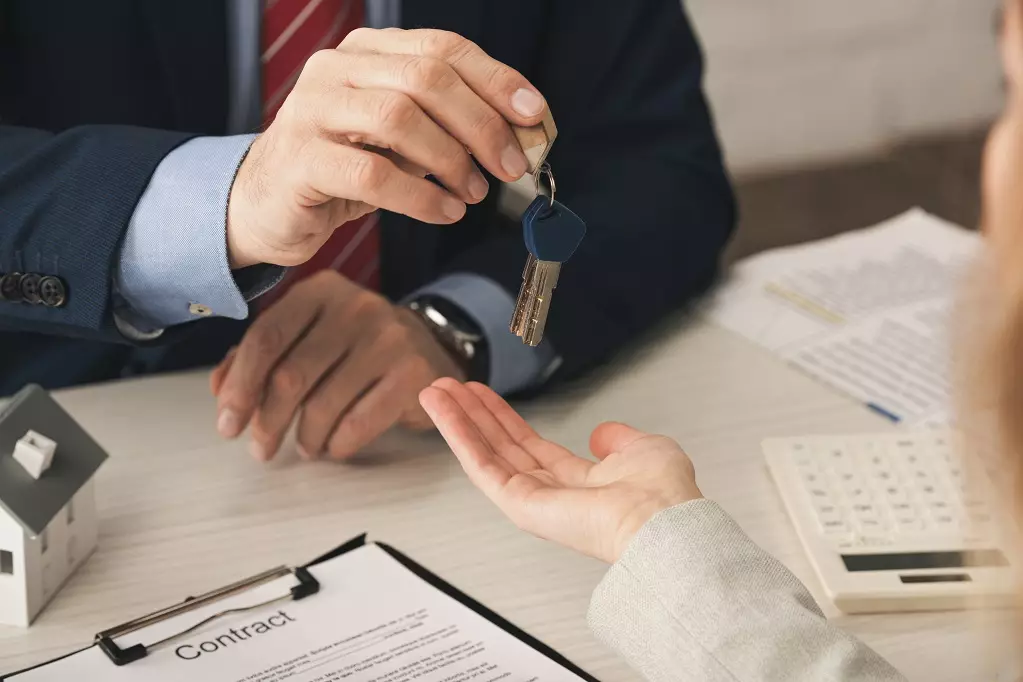 Realtor giving house key to the new owner